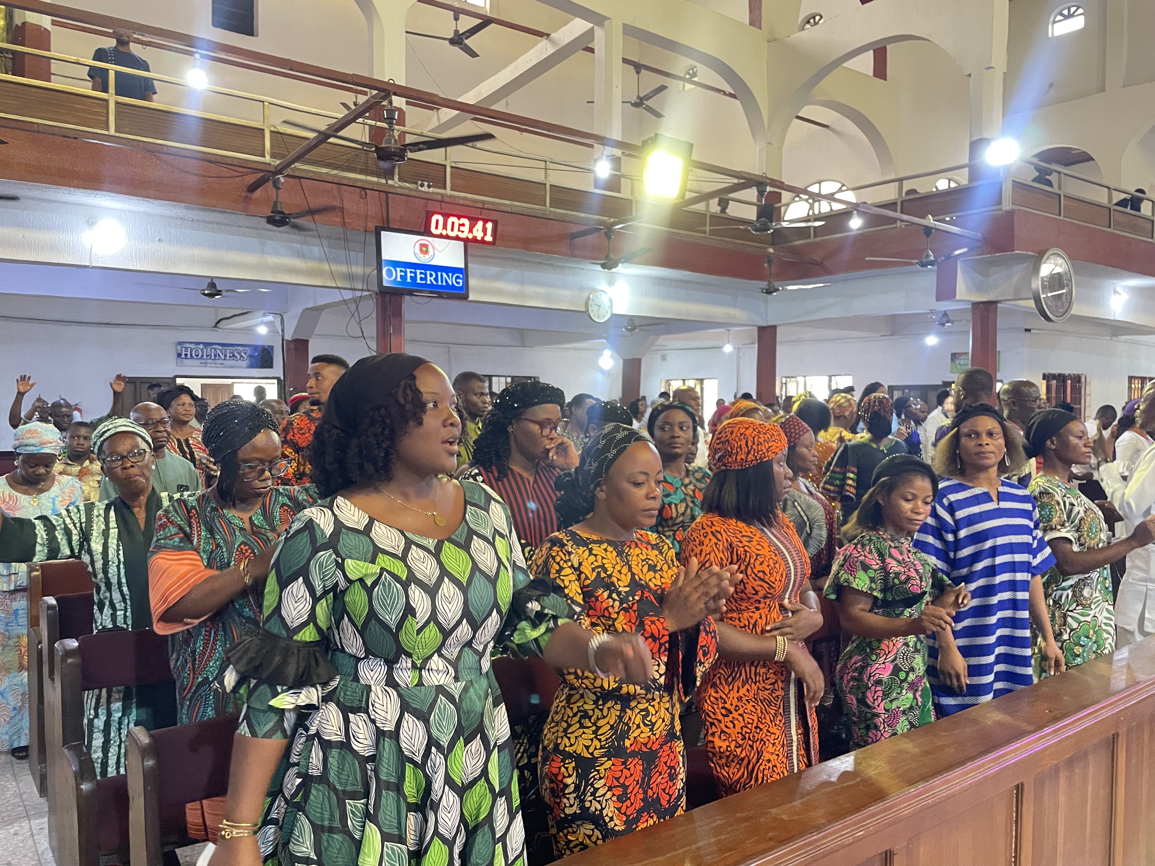 Congregants standing in worship inside Methodist Church Nigeria, Udo Umana