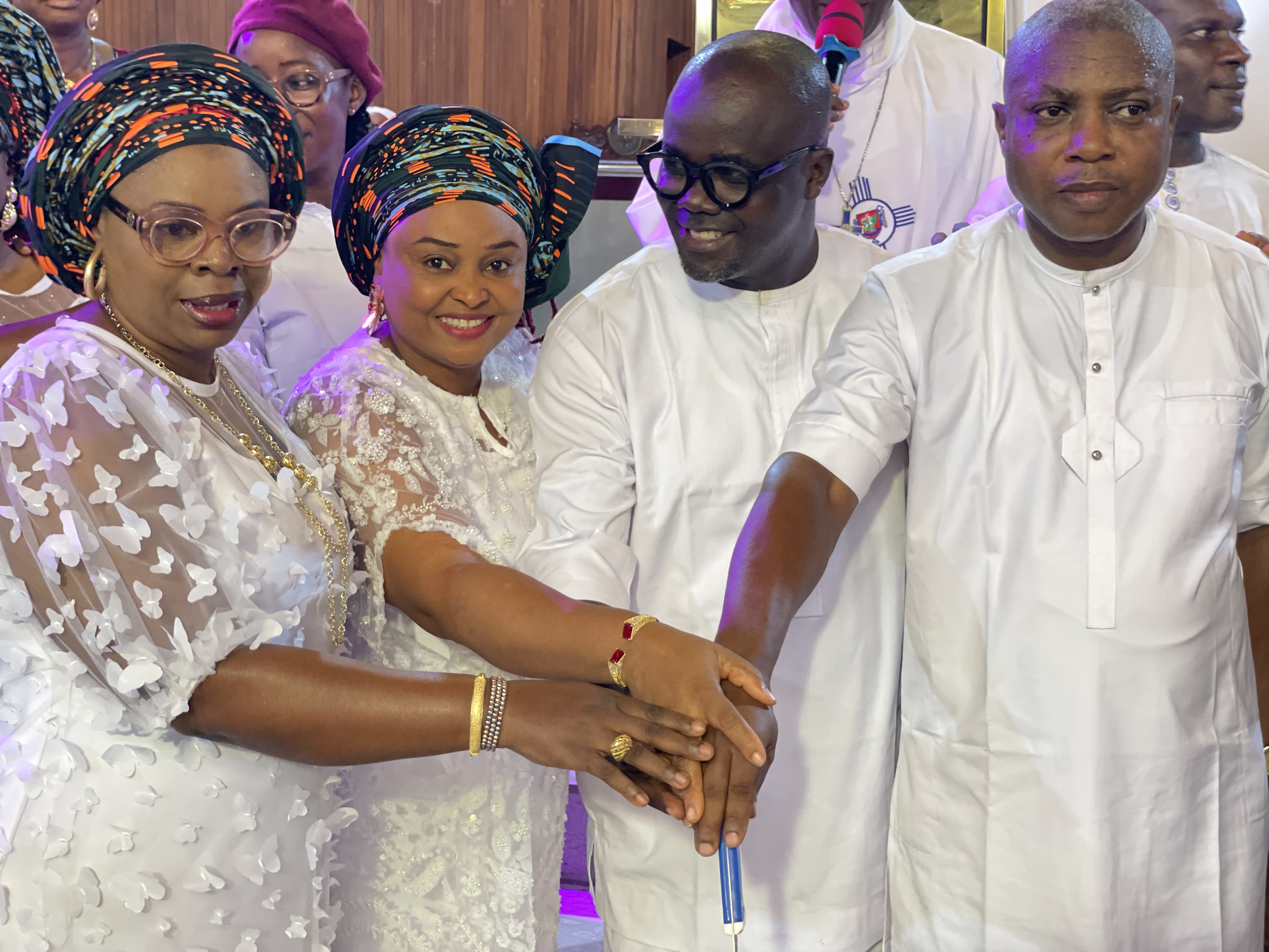 Church members and clergy joining hands during a service